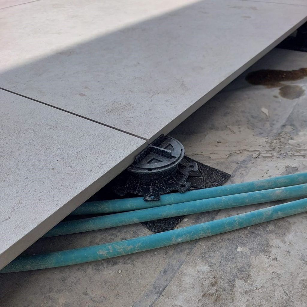 Electrical conduit running beneath the floating floor. Photo: Eyal Coatings