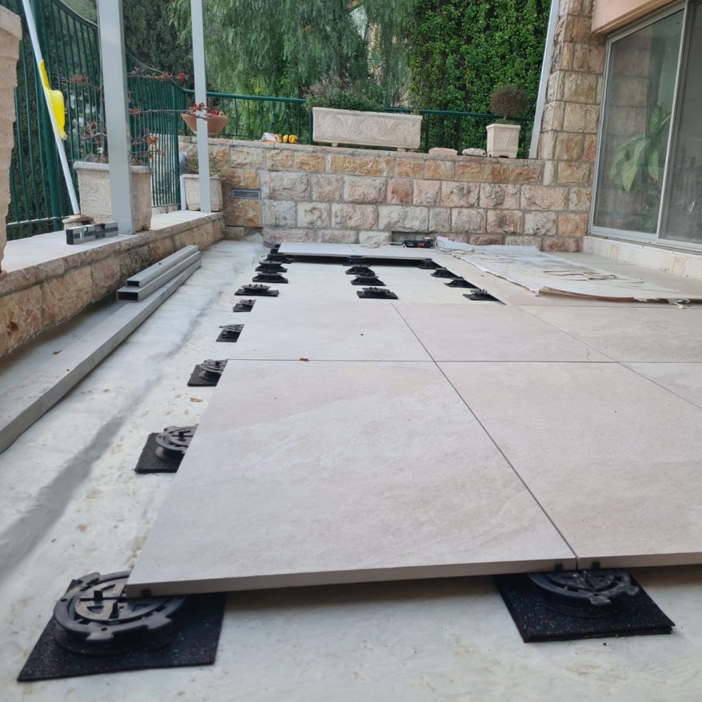 Balcony under construction with a raised floor using pedestals over waterproofing. Photo: Yoav Eshed EC